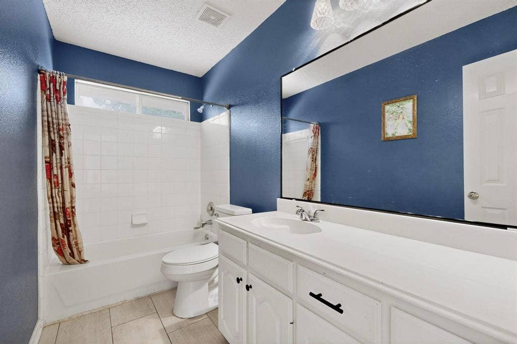 320 Elizabeth Trail, Murphy, TX 75094 Bathroom featuring a full vanity with integrated sink, white cabinetry, and a large wall-mounted mirror