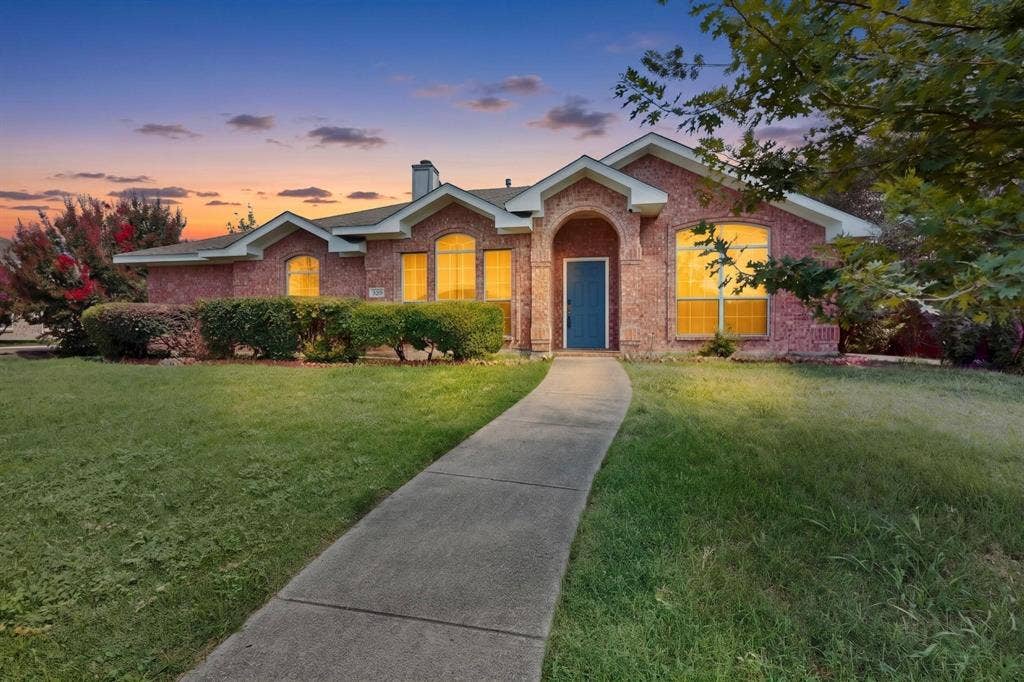 320 Elizabeth Trail, Murphy, TX 75094 Brick exterior with arched entry, gabled roofline, and established landscaping