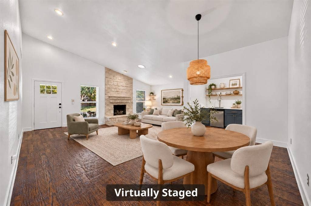 4448 Cleveland Drive, Plano, TX 75093 Hand-scraped hardwoods and decorator lighting bring warmth and character to the dining area overlooking the step-down living room. Virtually staged.