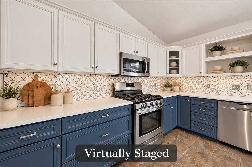 4448 Cleveland Drive, Plano, TX 75093 Beautifully updated kitchen pairs blue-and-white cabinetry with quartz countertops, a scalloped tile backsplash and a five-burner gas range. Virtually staged.