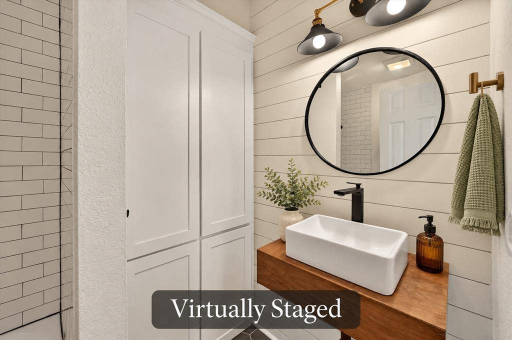 4448 Cleveland Drive, Plano, TX 75093 The hall bath blends character and function with a vessel sink, wood vanity top, shiplap detailing and tall storage cabinetry. Virtually staged.