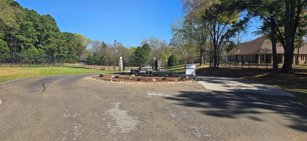 8300 Trophy Point, Larue, TX 75770 Gated entry with stone pillars, circular drive, and lush perimeter landscaping