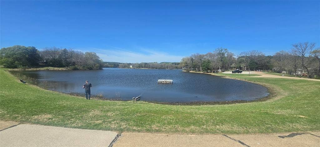 8300 Trophy Point, Larue, TX 75770 Expansive waterfront property featuring a manicured lawn and mature trees
