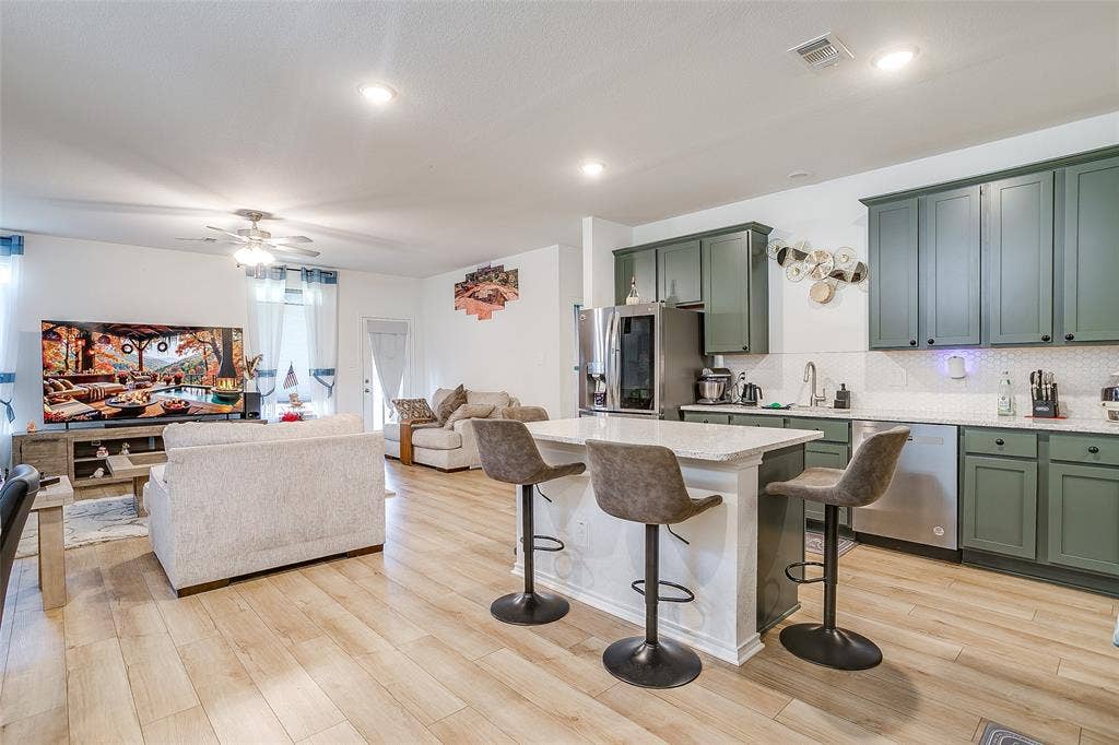 Open concept living space featuring wood-finish flooring, recessed lighting, and a ceiling fan