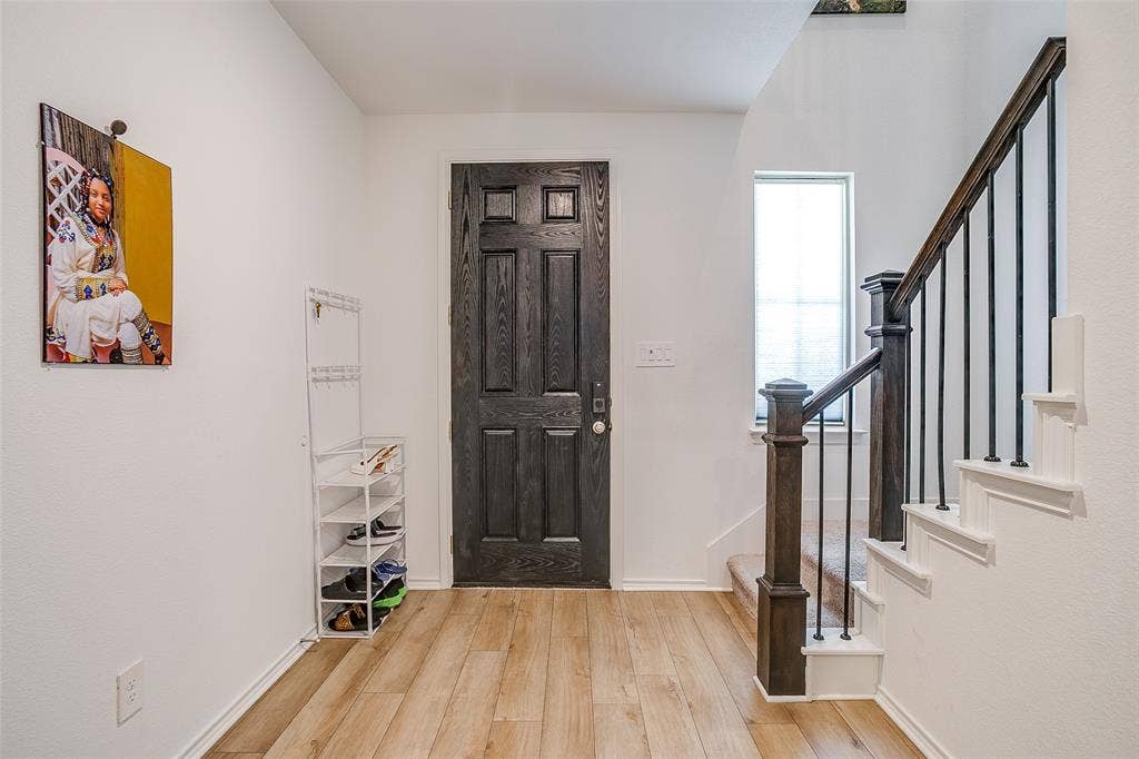 Wood-finish flooring with a contrasting dark paneled door