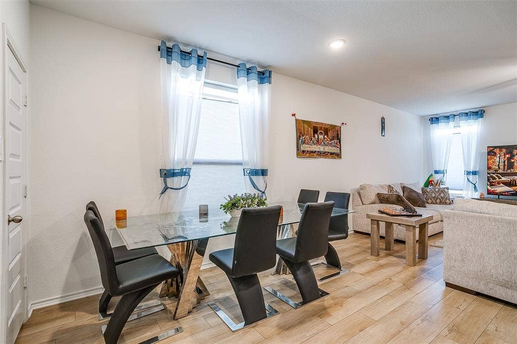 Recessed lighting, wood-finish flooring, white walls, and bright windows