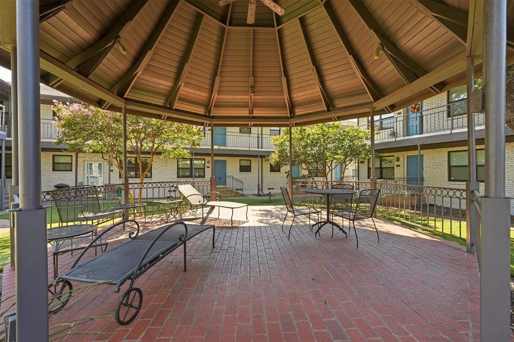 Gazebo with a solid roof structure and brick paver flooring