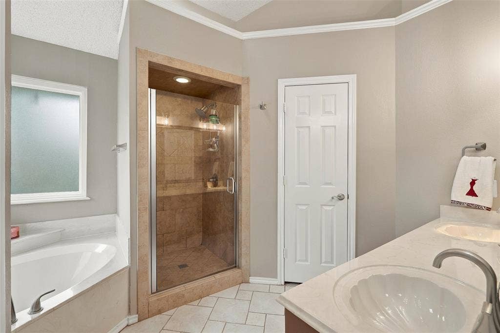 6036 Sundown Drive, Watauga, TX 76148 Primary bathroom with garden tub and separate shower. Dual vantities