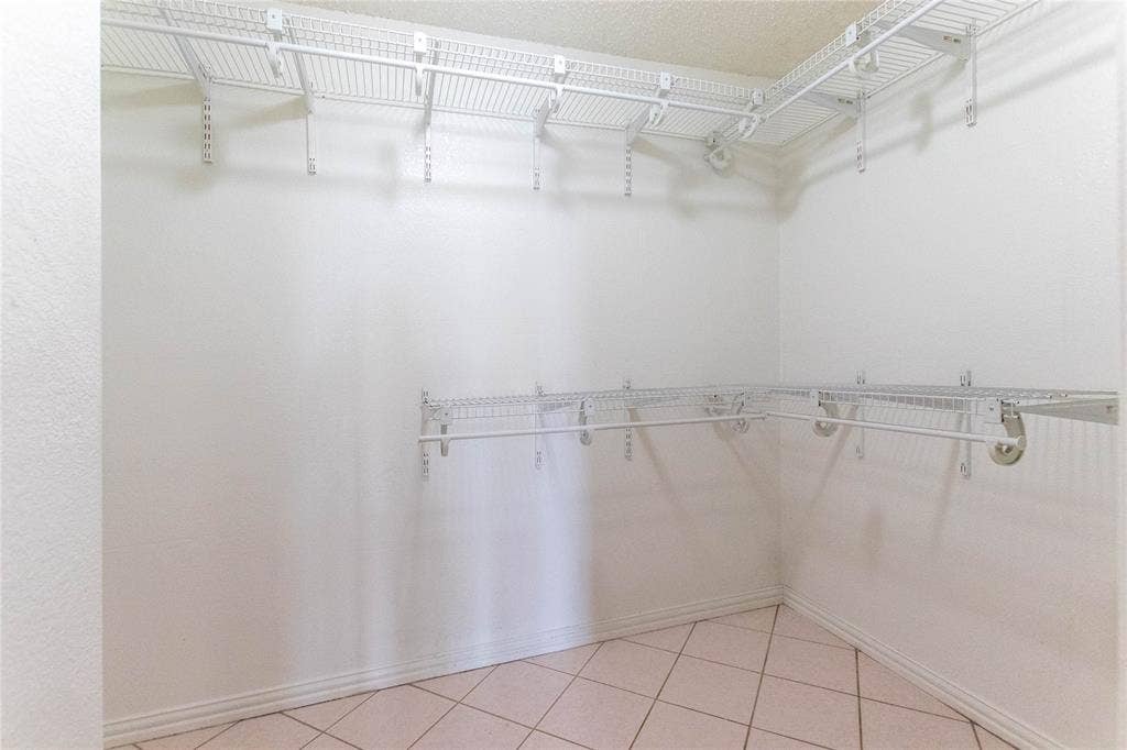 Built-in wire shelving system with hanging rods, offering abundant storage