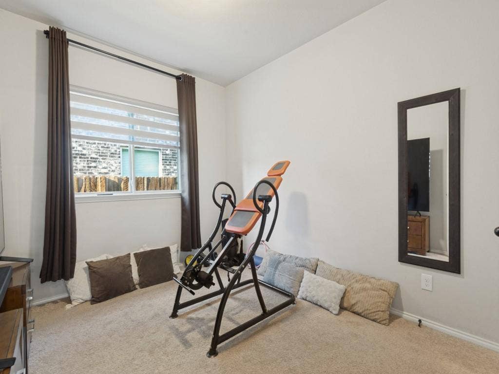 3825 S Courtney Court, Heartland, TX 75126 Neutral wall color, carpeted flooring, and a large window with blinds