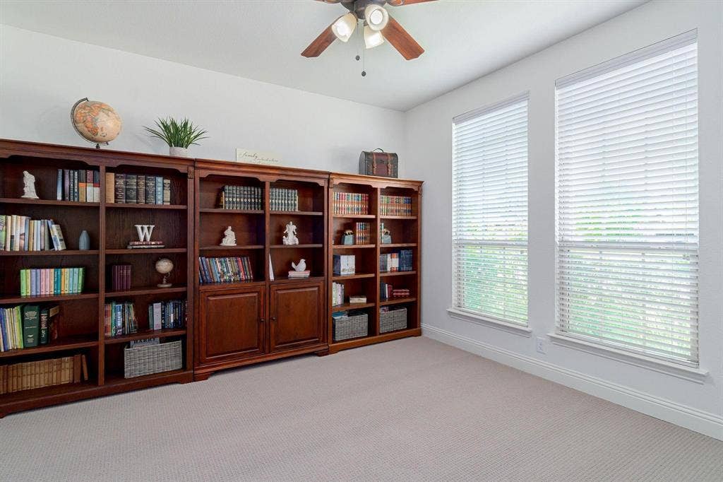 Recessed lighting, ceiling fan, twin windows with blinds, and light-tone carpeting