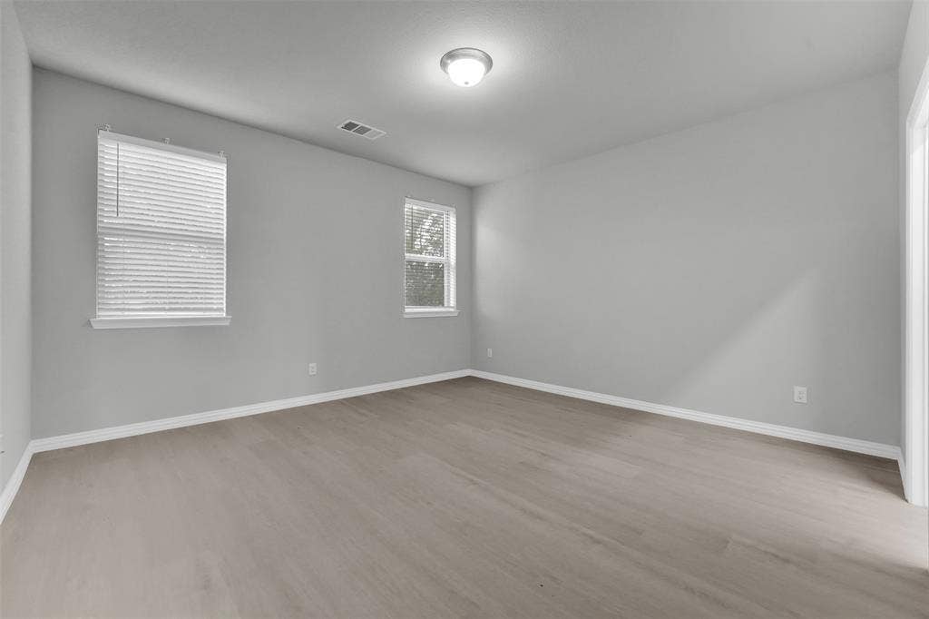 8266 Primrose Way, Dallas, TX 75252 Wood-finish flooring, multiple windows with blinds, recessed lighting, and light gray wall finishes
