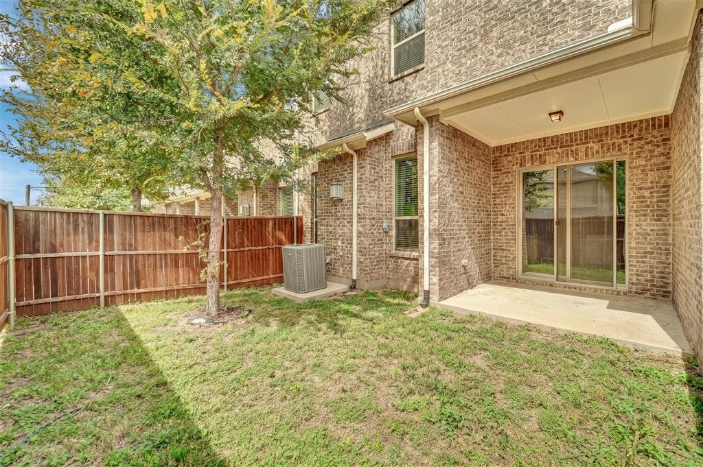 8266 Primrose Way, Dallas, TX 75252 Brick exterior with a covered patio, concrete slab, and sliding glass door