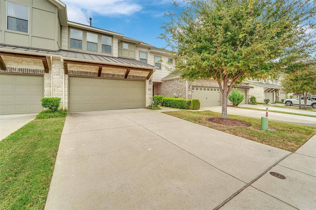 8266 Primrose Way, Dallas, TX 75252 Two-story exterior with stone and siding accents, prominent garage with a covered entrance, and a concrete driveway