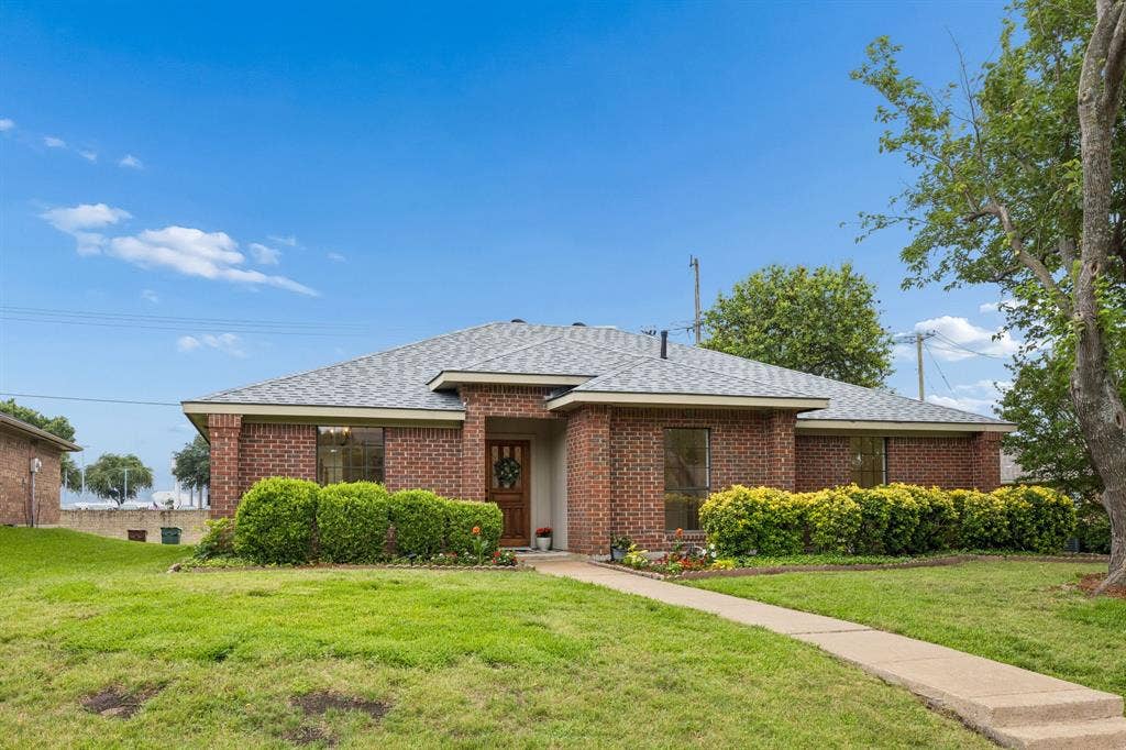 4540 New Orleans Drive, Plano, TX 75093 Red brick exterior with a grey shingle roof