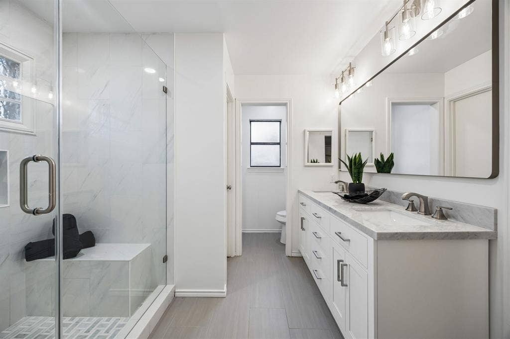 4540 New Orleans Drive, Plano, TX 75093 Walk-in shower with clear glass enclosure and built-in bench