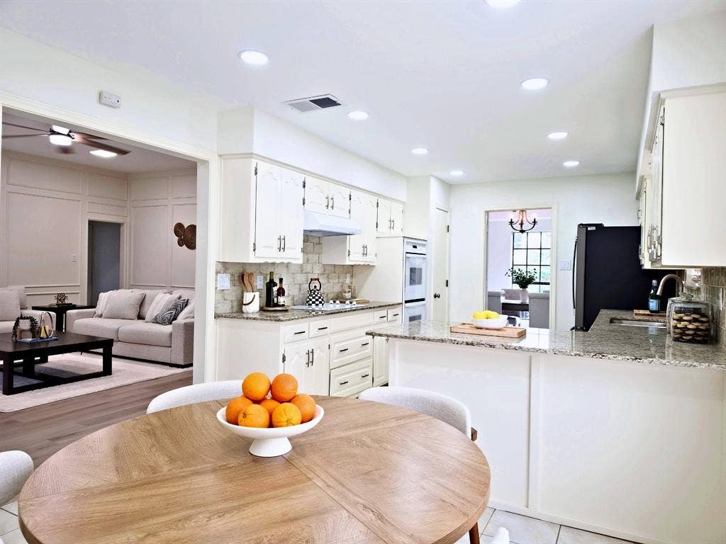4540 New Orleans Drive, Plano, TX 75093 Kitchen with white cabinetry, light-colored granite countertops, and a subway tile backsplash