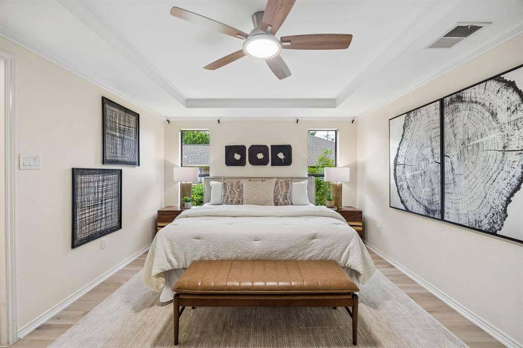 4540 New Orleans Drive, Plano, TX 75093 Tray ceiling with crown molding, ceiling fan with integrated lighting, wood-finish flooring, recessed windows, and neutral wall tones