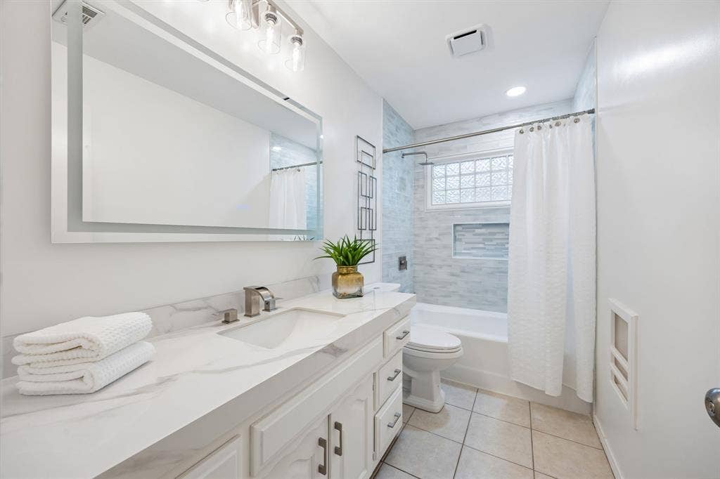 4540 New Orleans Drive, Plano, TX 75093 Vanity with a solid surface countertop, undermount sink, and brushed nickel faucet
