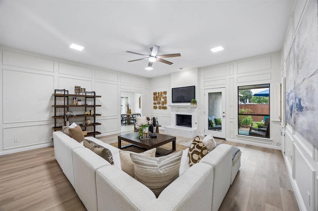 4540 New Orleans Drive, Plano, TX 75093 Living area featuring light wood-finish flooring, white paneling, and a ceiling fan