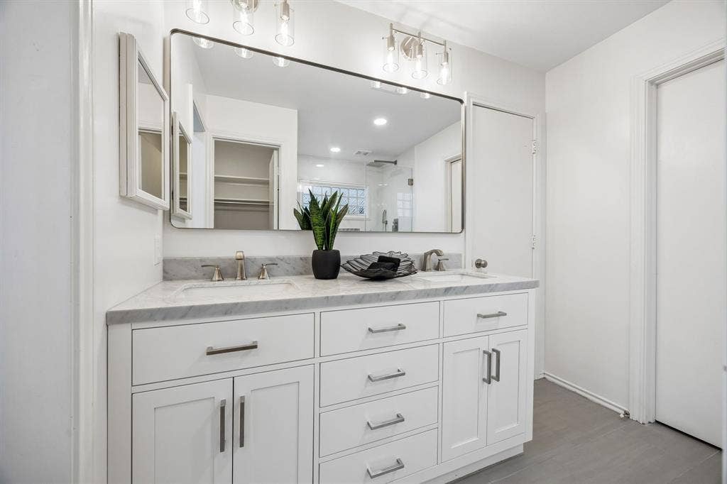 4540 New Orleans Drive, Plano, TX 75093 Dual vanity with white cabinetry, integrated sinks, a stone countertop, and brushed nickel hardware