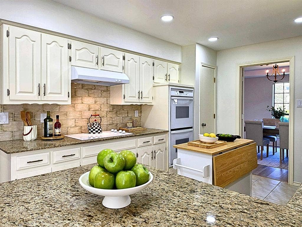 4540 New Orleans Drive, Plano, TX 75093 Kitchen featuring white cabinetry, granite countertops, a tiled backsplash, built-in double ovens, and recessed lighting