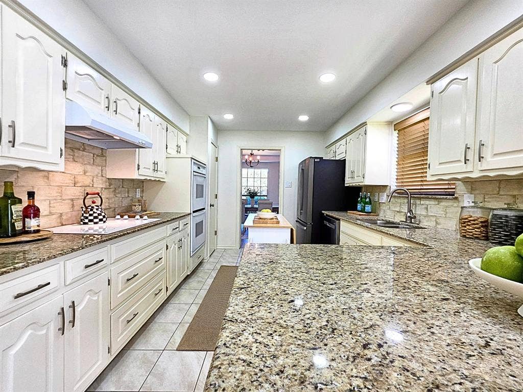 4540 New Orleans Drive, Plano, TX 75093 Kitchen featuring granite countertops, white cabinetry, a tile backsplash, recessed lighting, and tile flooring