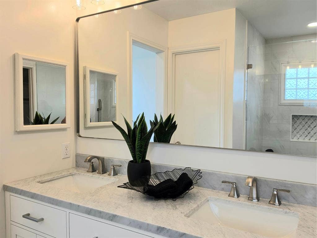 4540 New Orleans Drive, Plano, TX 75093 Dual undermount sinks with brushed nickel faucets, set in a light-colored stone countertop