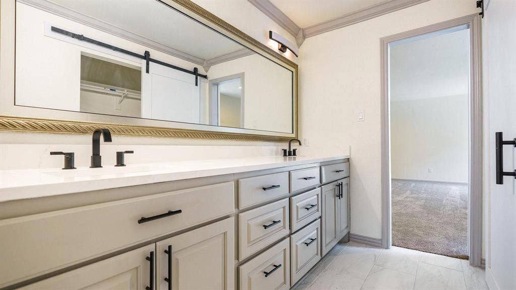 2616 Ellis Court, Plano, TX 75075 Dual vanity with a white countertop, undermount sinks, and matte black fixtures