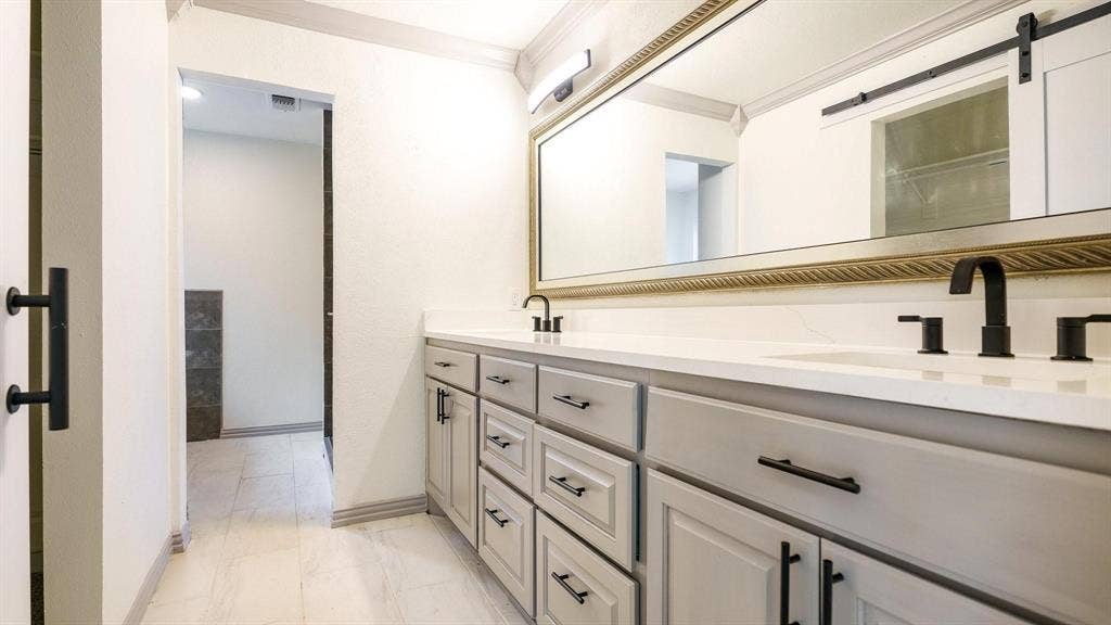 2616 Ellis Court, Plano, TX 75075 Dual vanity with matte black fixtures, light-toned cabinetry, and a large wall-mounted mirror