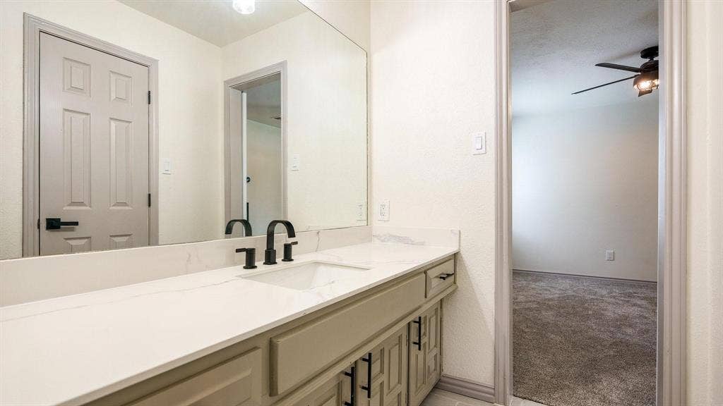 2616 Ellis Court, Plano, TX 75075 Vanity with a single basin sink, matte black faucet, and white countertop