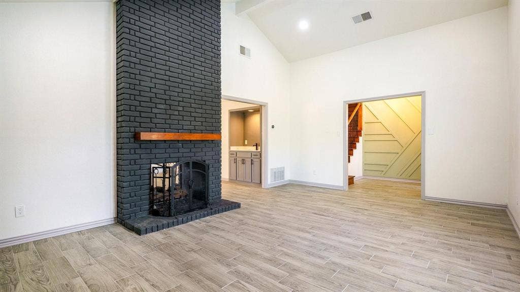 2616 Ellis Court, Plano, TX 75075 Vaulted ceilings complement the brick fireplace with wood mantel