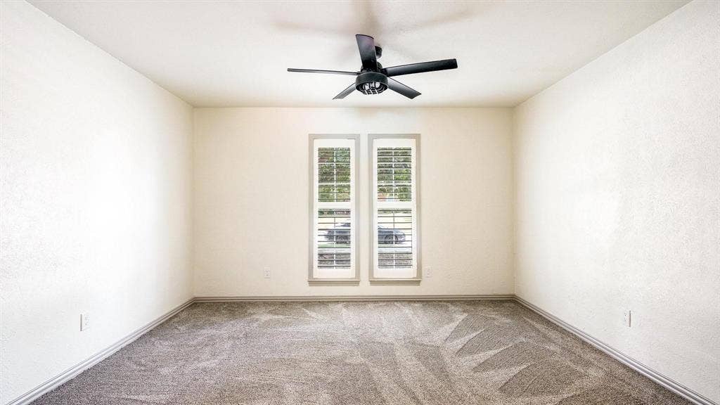2616 Ellis Court, Plano, TX 75075 Neutral wall color, carpeted flooring, two windows with plantation shutters, ceiling fan with integrated lighting, and crown molding