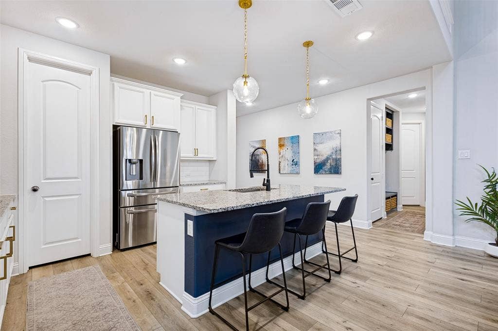 912 Lady Bird Drive, McKinney, TX 75071 Updated lighting in kitchen, Microwave and dishwasher replaced.