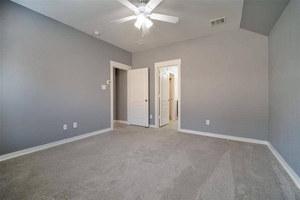 2324 Neff Lane, Forney, TX 75126 Vaulted ceiling featuring a central ceiling fan with integrated lighting, neutral wall paint, and wall-to-wall carpeting