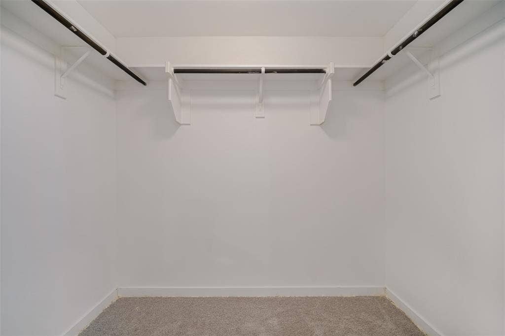 2324 Neff Lane, Forney, TX 75126 Walk-in closet featuring white walls, carpeting, and multi-tiered shelving with hanging rods