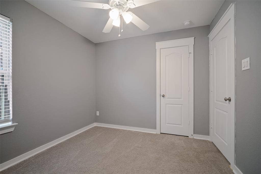 2324 Neff Lane, Forney, TX 75126 Room featuring wall-to-wall carpeting, neutral interior paint, a ceiling fan with integrated lighting, and two multi-panel interior doors