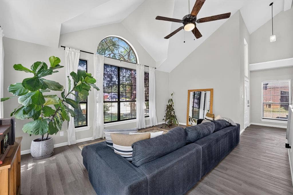 519 Fox Creek Court, Denton, TX 76209 Vaulted ceilings, a dark wood-finish ceiling fan, and large windows with an arched transom