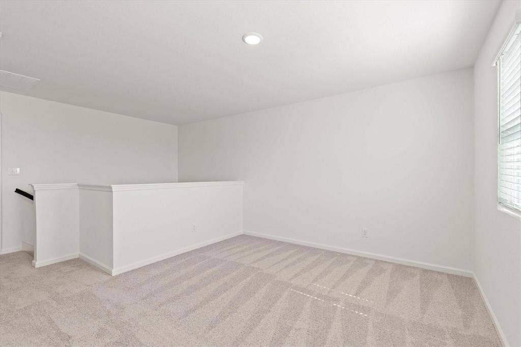 3208 Dillonwood Street, Celina, TX 75009 Upstairs Living Area; Neutral-toned carpeting, white walls, and a single window with blinds