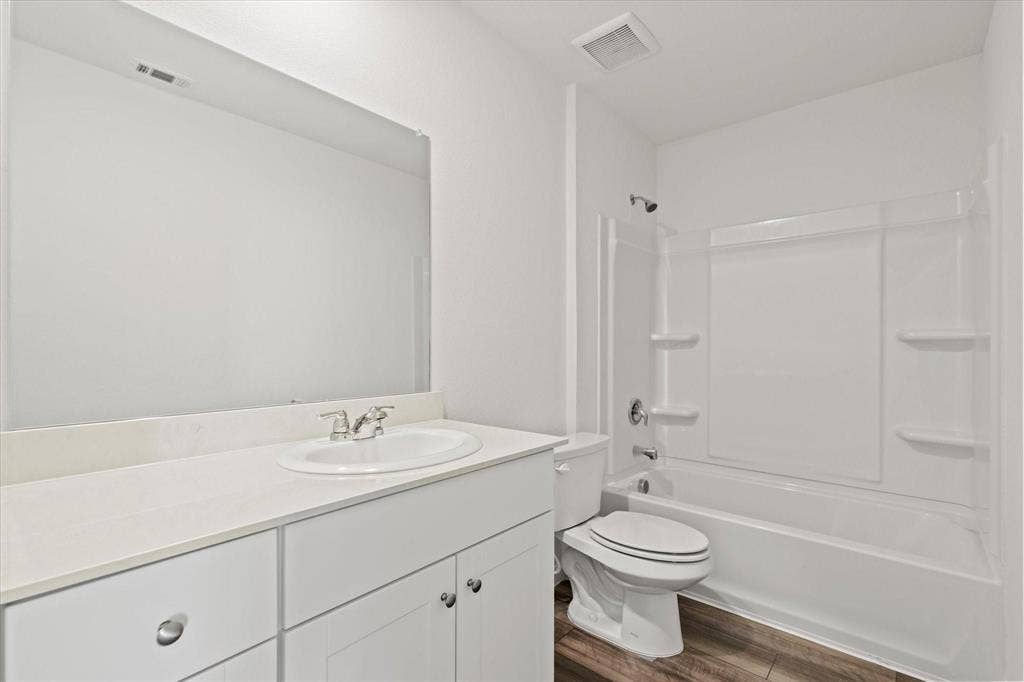 3208 Dillonwood Street, Celina, TX 75009 White vanity with integrated sink, polished chrome faucet, and expansive mirror