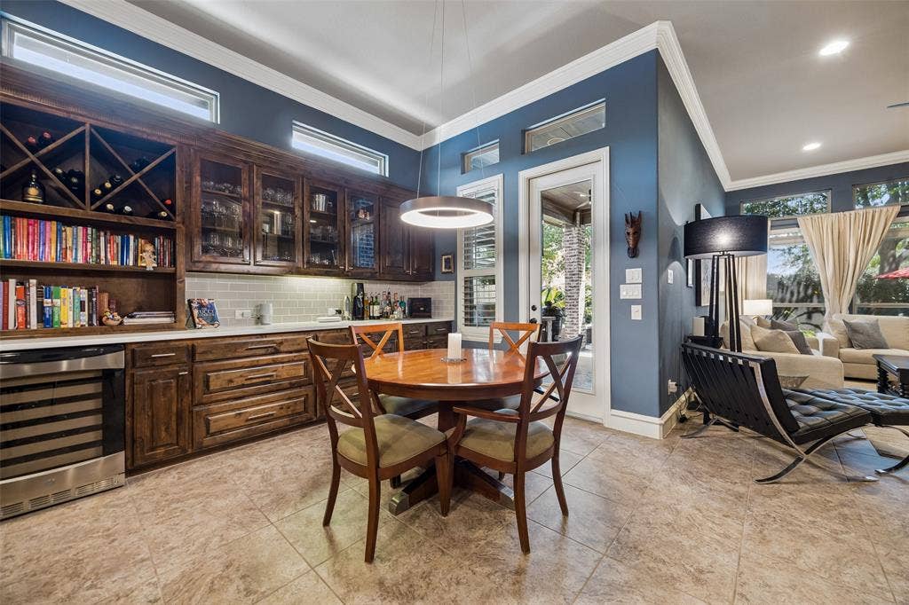 6009 Heron Bay Lane, McKinney, TX 75070 Additional seating and a Bar or coffee area with glass cabinet inserts.
