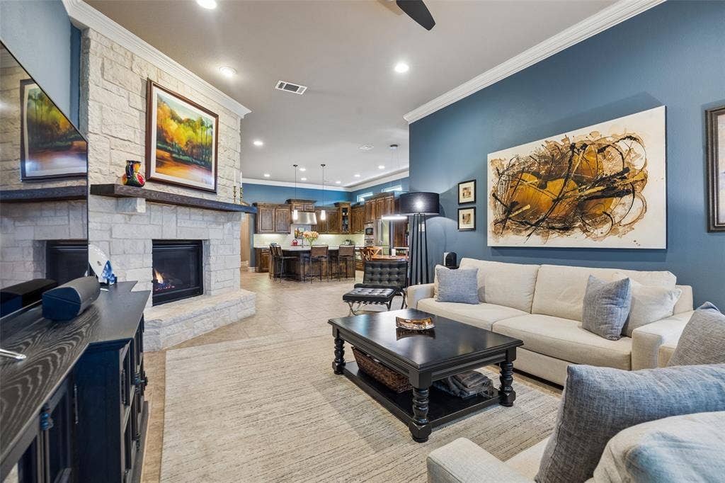 6009 Heron Bay Lane, McKinney, TX 75070 Gorgeous stone gas fireplace.