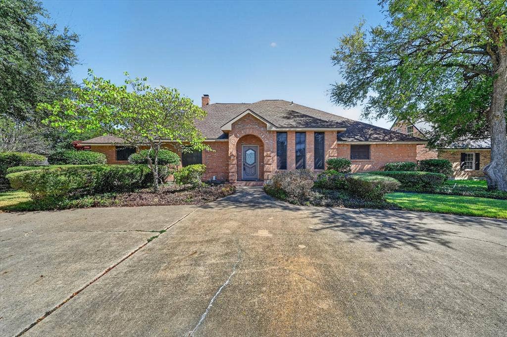 206 Harris Drive, Sunnyvale, TX 75182 Brick exterior with a gabled roof and arched entryway