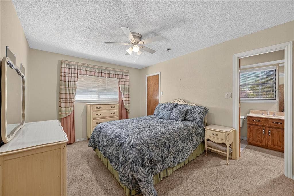 206 Harris Drive, Sunnyvale, TX 75182 Recessed window with blinds, ceiling fan with integrated lighting, wood-finish door, and carpeted flooring