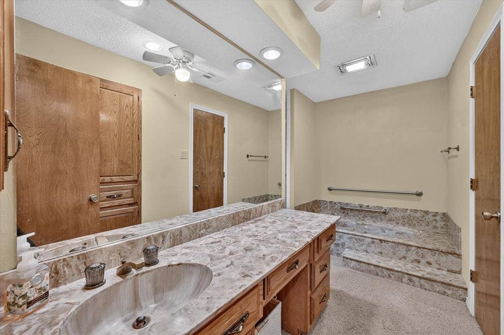 206 Harris Drive, Sunnyvale, TX 75182 Extended vanity with integrated sink, full-width mirror, and ample wood cabinetry