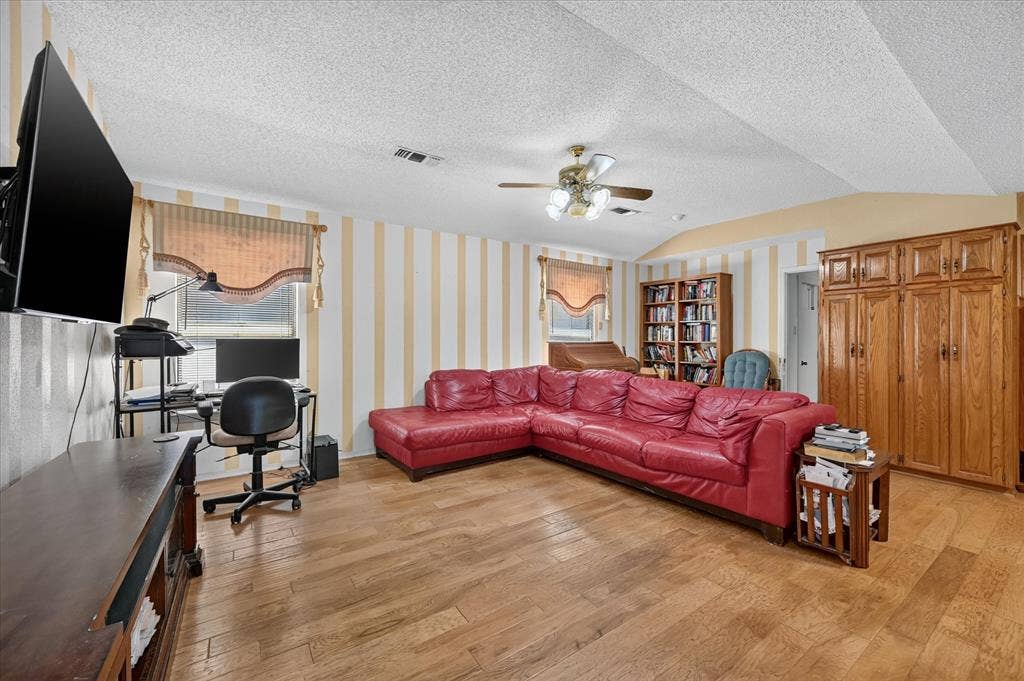 206 Harris Drive, Sunnyvale, TX 75182 Wood-finish flooring, built-in wooden cabinetry, a built-in ceiling fan, and window treatments