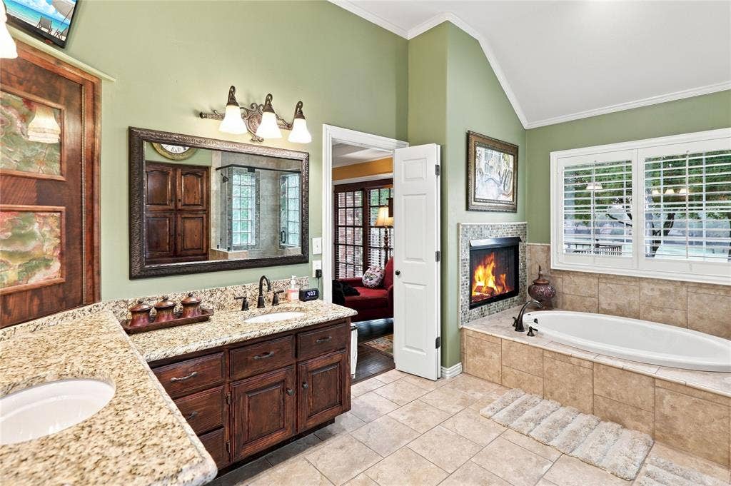1204 Hills Creek Drive, McKinney, TX 75072 Dual vanity with granite countertops, wood cabinetry, and integrated sinks