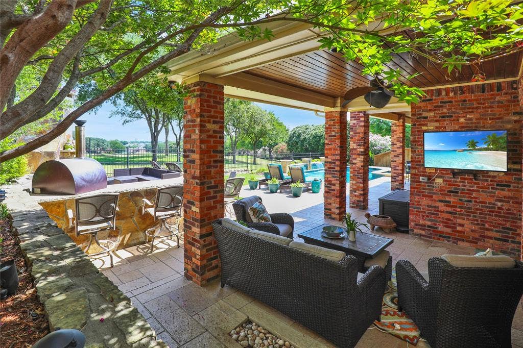 1204 Hills Creek Drive, McKinney, TX 75072 Covered patio with brick columns, wood-paneled ceiling, and recessed lighting