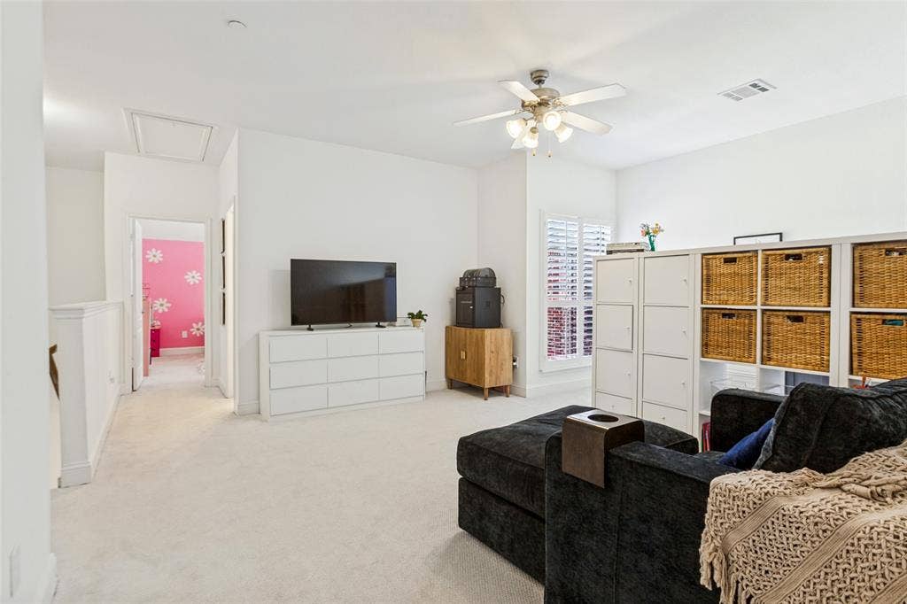 6816 Livorno Lane, Frisco, TX 75034 Large bonus room with potential for future 3rd bedroom, Carpeted flooring, ceiling fan, and window with plantation shutters. Great, office, gym, playroom etc