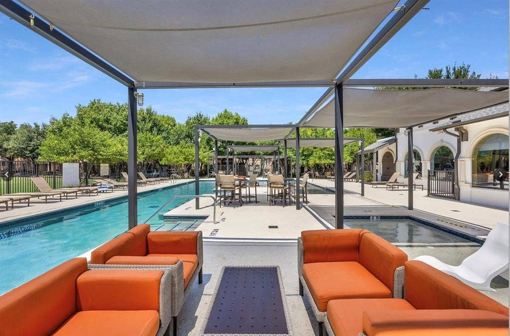 6816 Livorno Lane, Frisco, TX 75034 Expansive outdoor pool area featuring a long swimming pool, separate spa, and multiple shaded seating zones